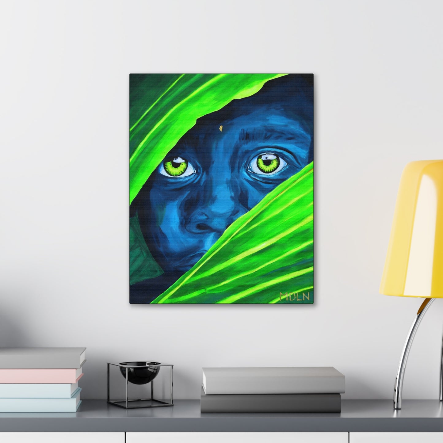 An art print on canvas of a blue African Boy hanging on the wall over a table