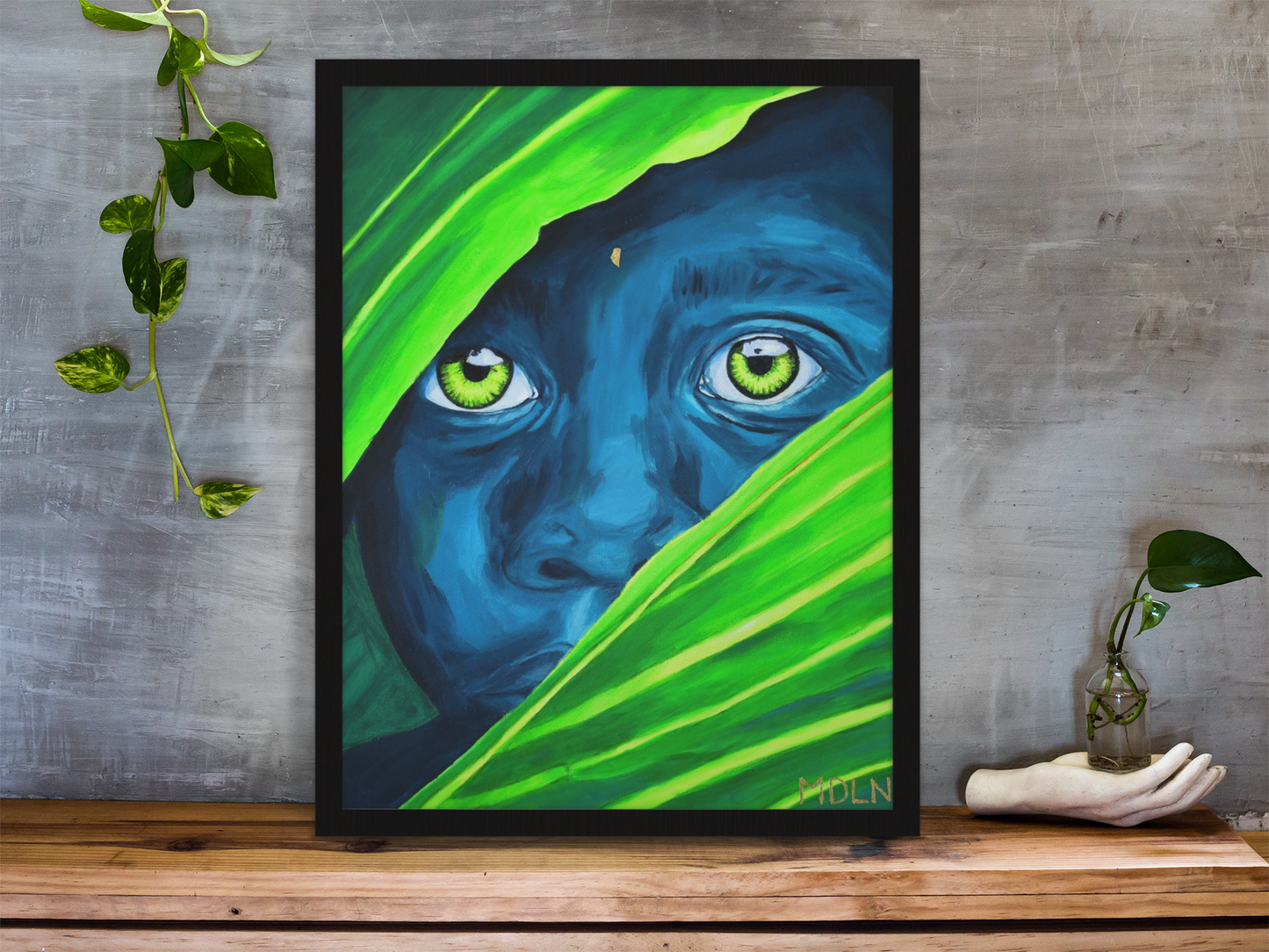 An original acrylic painting of an a young African Child with bright eyes peaking out from beyond some palm leaves, sitting on a table