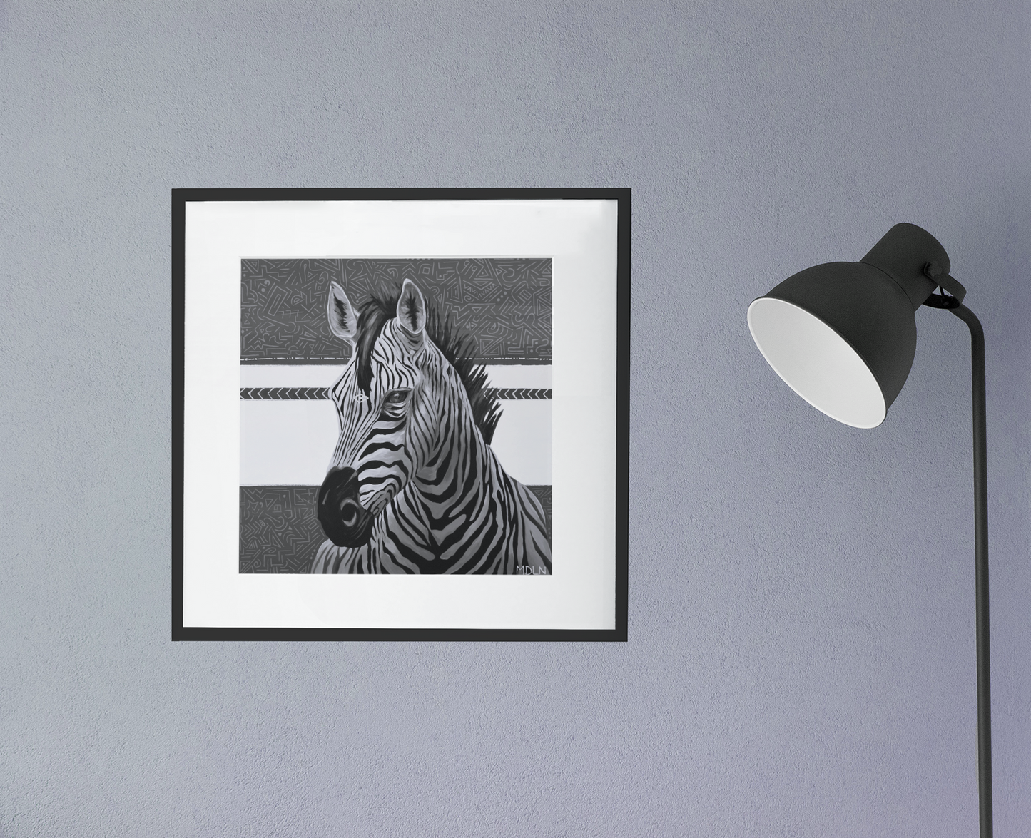 A black and white giclee art print of a majestic zebra painting with abstract background, zebra art framed in black with white matting, hanging on a wall next to a lamp