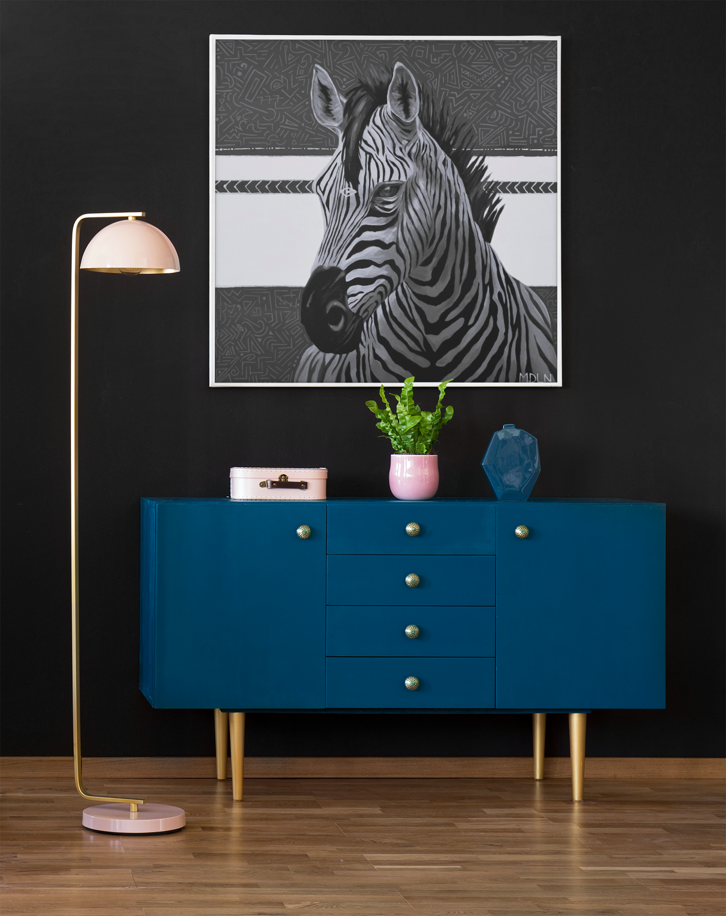 A black and white giclee art print of a majestic zebra painting with abstract background, zebra art hanging on a wall over a cabinet next to a lamp