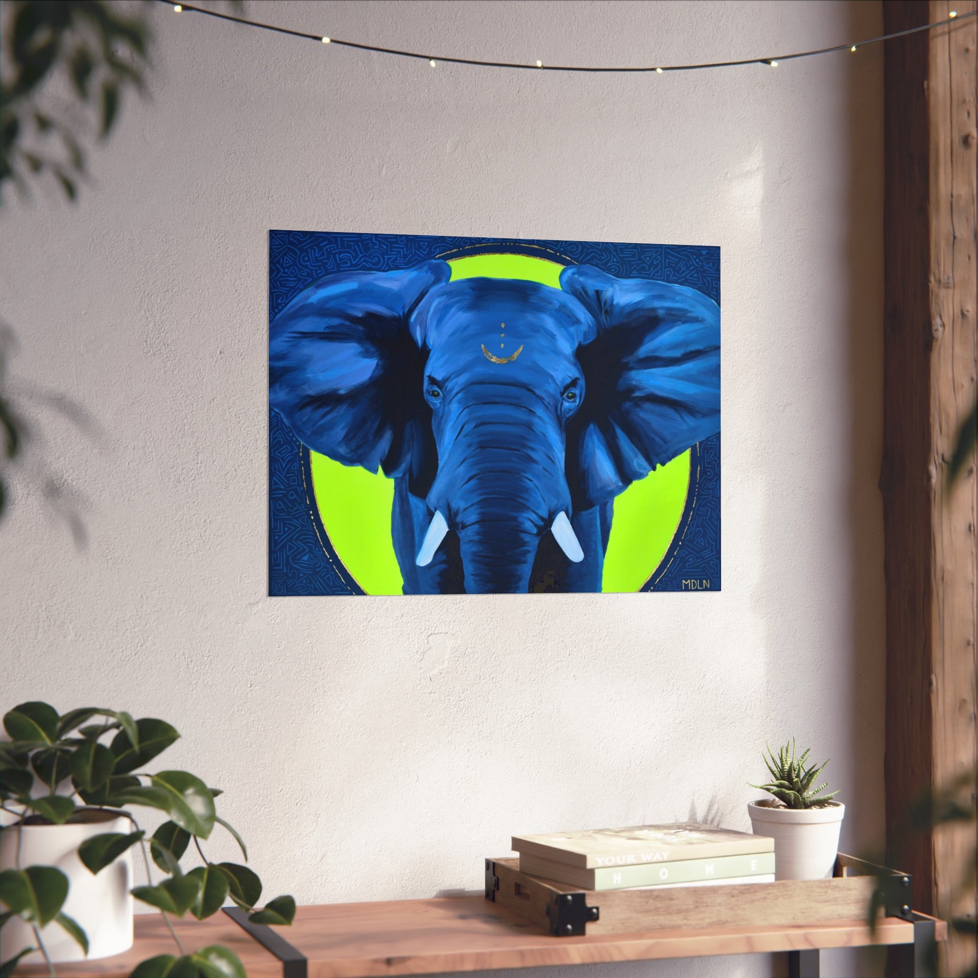 A blue and yellow African Elephant art print hanging on the wall over a console table