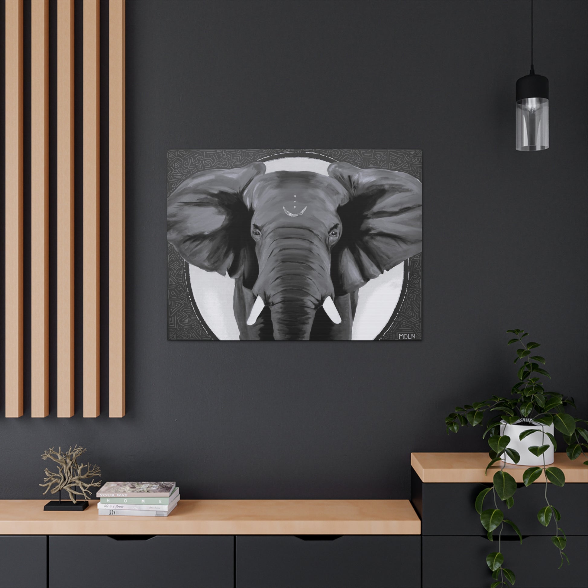 Black, grey and white canvas print of an African elephant hanging on a black wall of an office