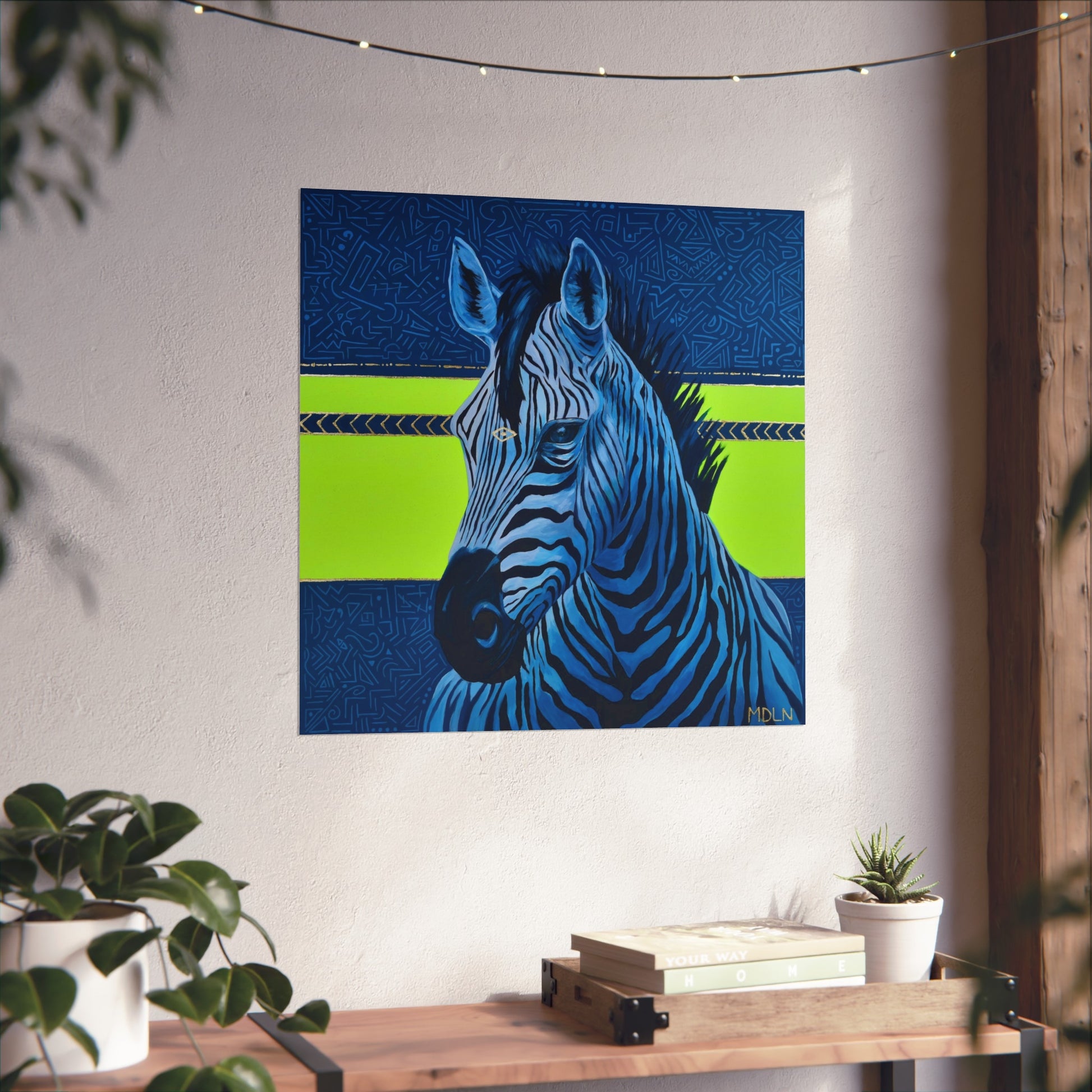 A bright and bold giclee art print of a majestic zebra painting with blue and neon yellow abstract background, zebra art hanging on a wall over a wooden table