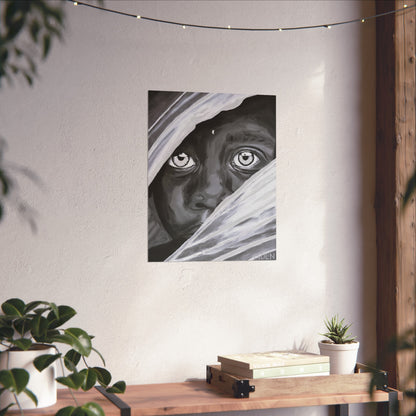 A black and white giclee art print of an African Boy hanging on a wall over a console table