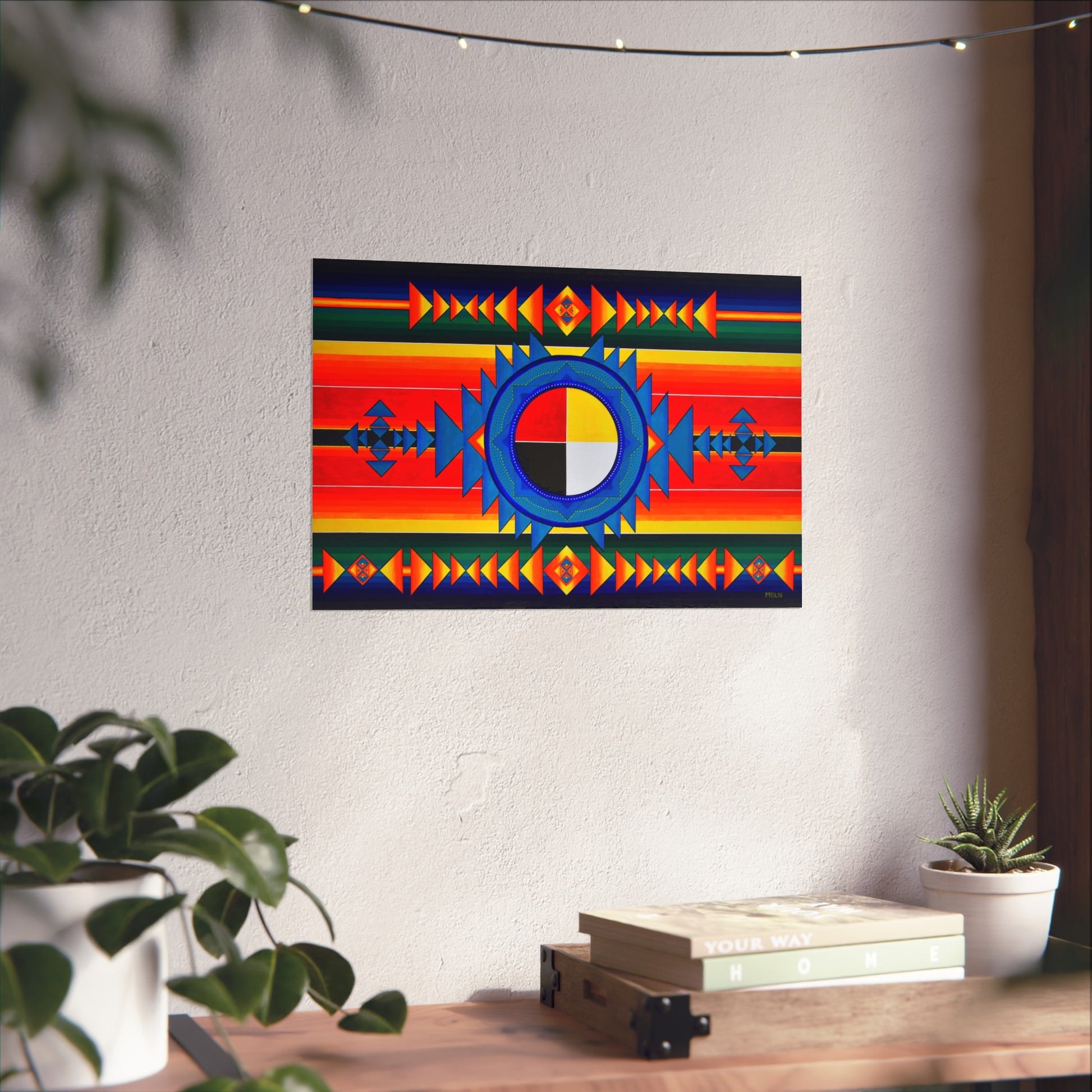 A bright and colorful Indigenous Medicine Wheel giclee art print hanging on a wall over a table