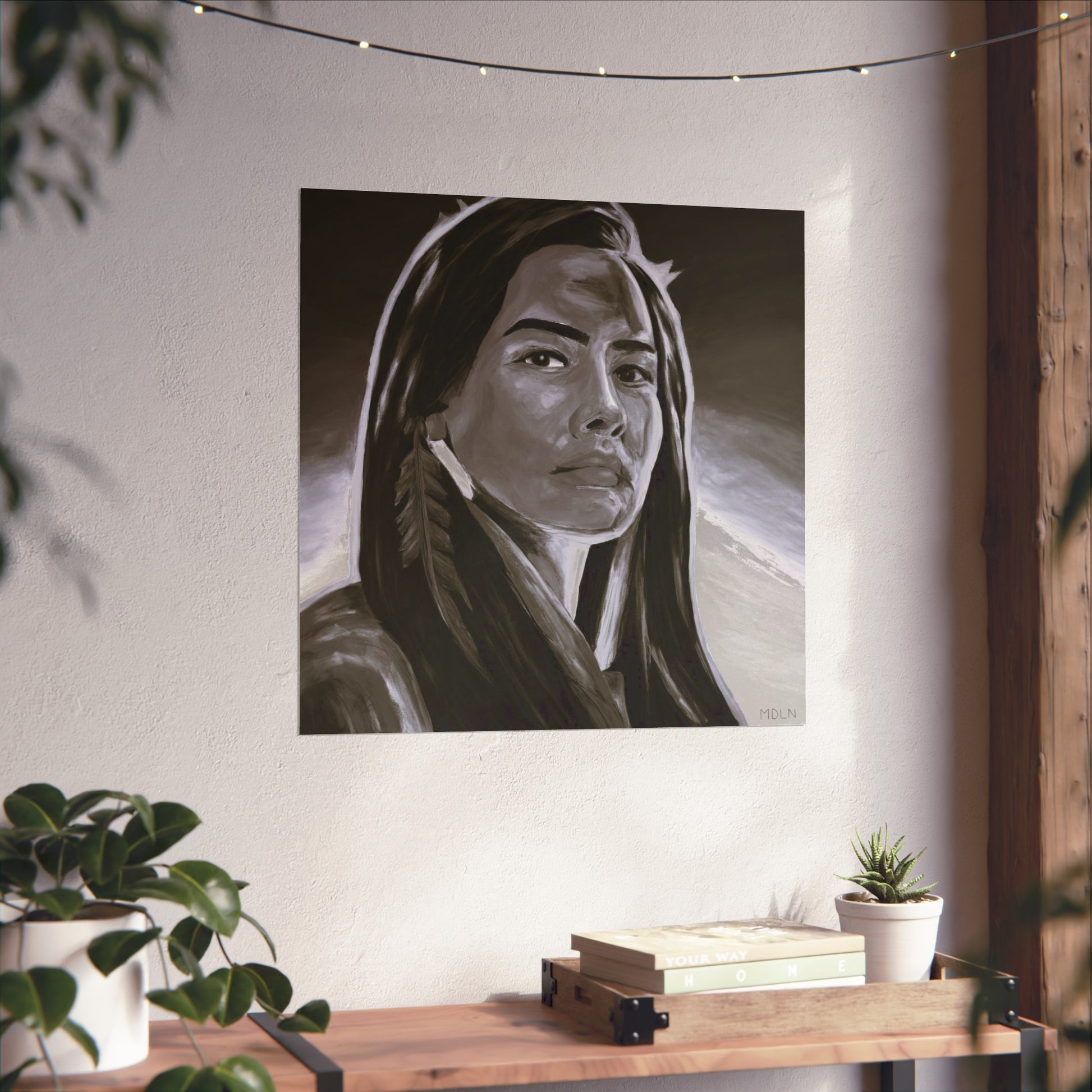 Beautiful black and white Indigenous giclee art print of an Aboriginal Woman with feather earring, hanging on the wall over a table