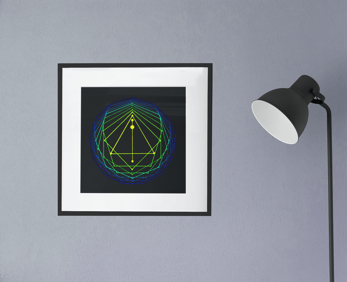 Giclee art print of an original acrylic painting of sacred geometry in blue/green/yellow tones, framed, hanging on a wall next to a lamp'