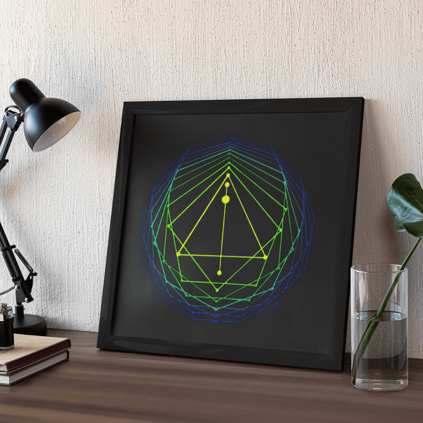 Sacred Geometry Art Original Acrylic Painting in neon yellow, green and blue, framed, leaning up against a wall on a desk