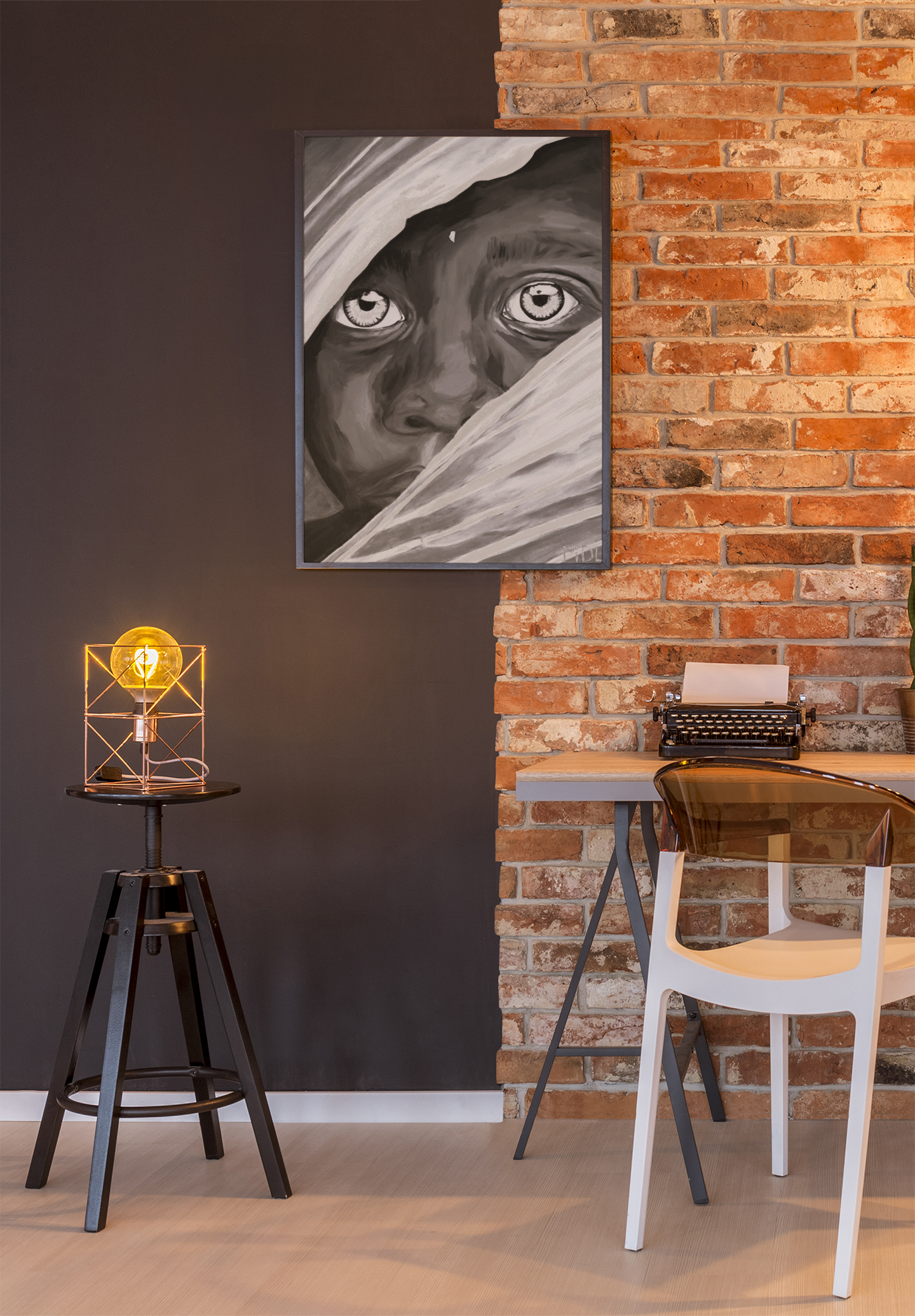 A black and white giclee art print of an African Boy hanging up on a brick wall over a desk