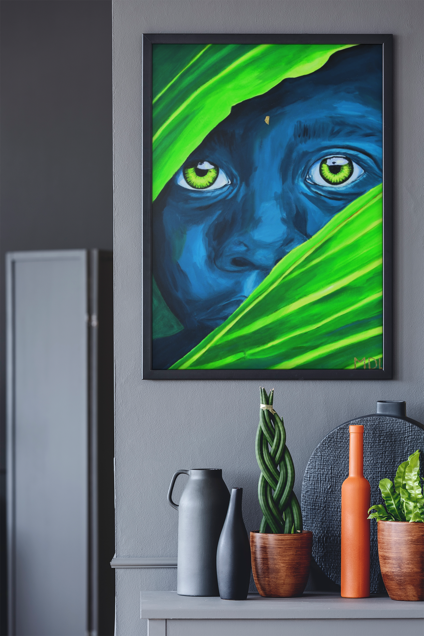 A giclee art print of an African Boy hanging on the wall over a table with objects on it