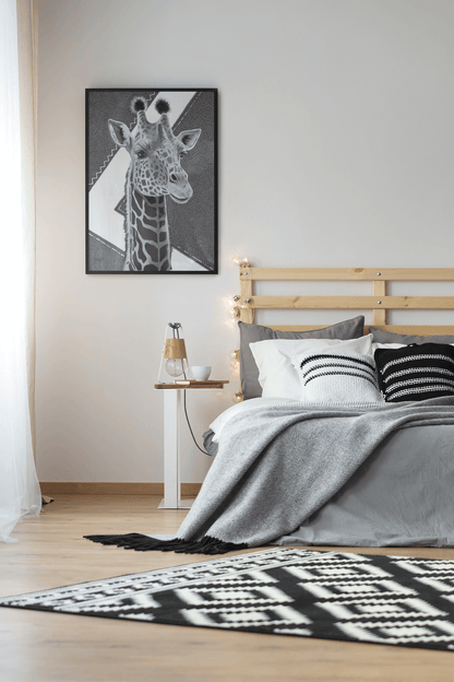 Black and white giclee art print of an original acrylic painting with gold leaf of a majestic giraffe drawing, with geometry in the background, framed, hanging on the wall in a modern bedroom