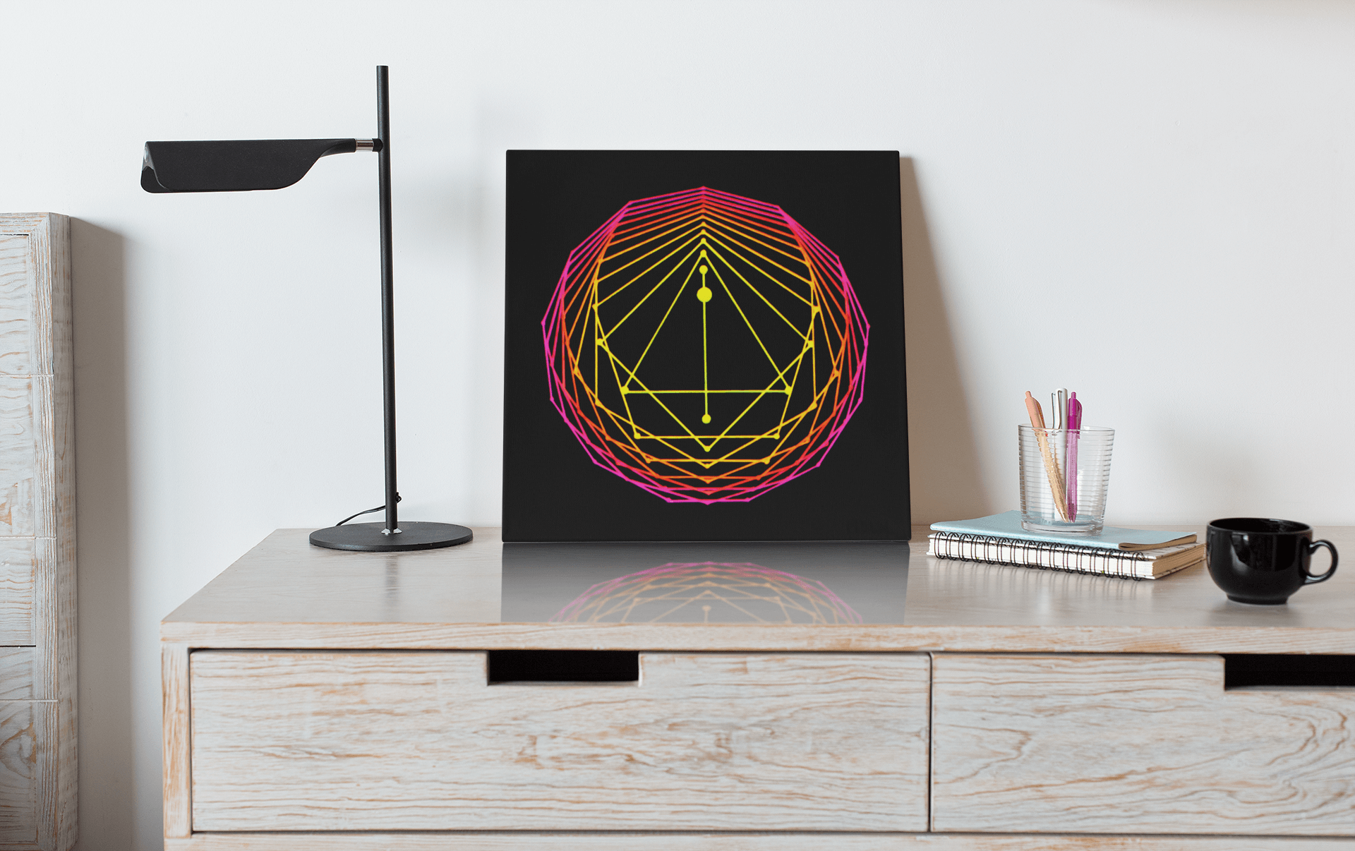 Sacred Geometry Art Original acrylic painting in neon yellow, orange and pink, leaning up against a wall on a desk