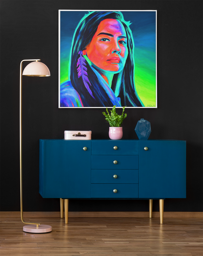 An original acrylic painting of a pretty Aboriginal Woman with feather earring, Indigenous Art hanging on a wall over a cabinet next to a lamp