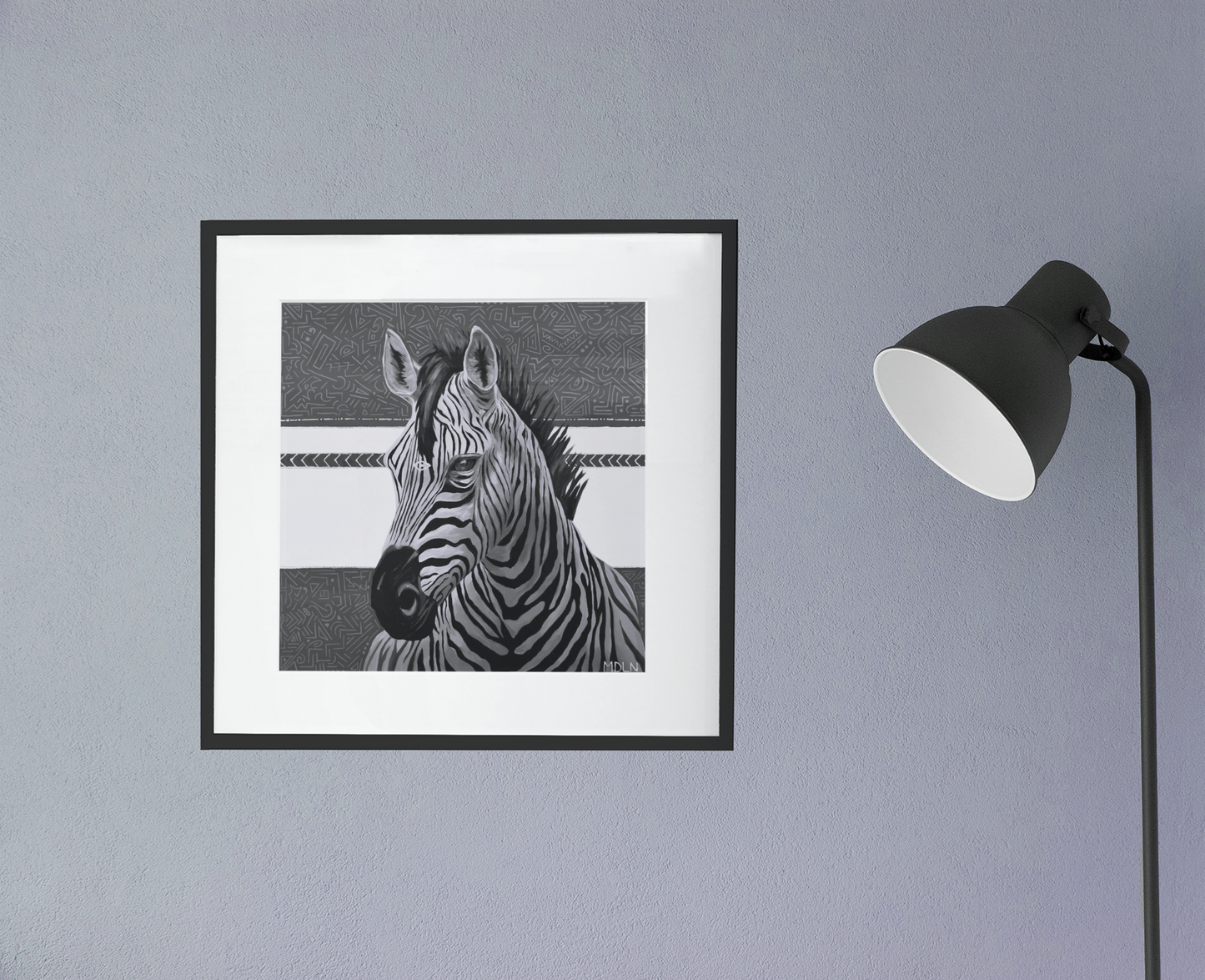 A black and white  giclee art print of a majestic zebra painting with abstract background, zebra art framed in black with white matting, hanging on a wall next to a lamp