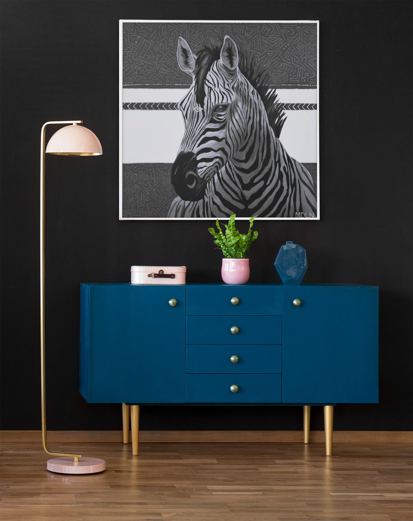 A black and white  giclee art print of a majestic zebra painting with abstract background, zebra art hanging on a wall over a cabinet next to a lamp